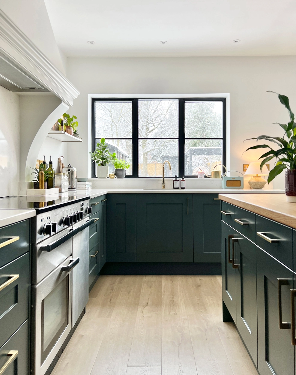 Blue green shaker kitchen with Crittall style window