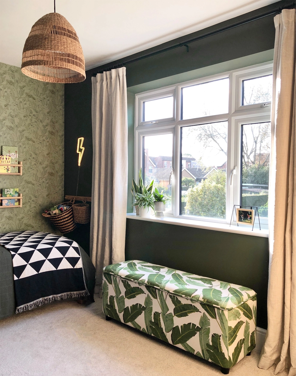 Child's room in dark green with dino wallpaper