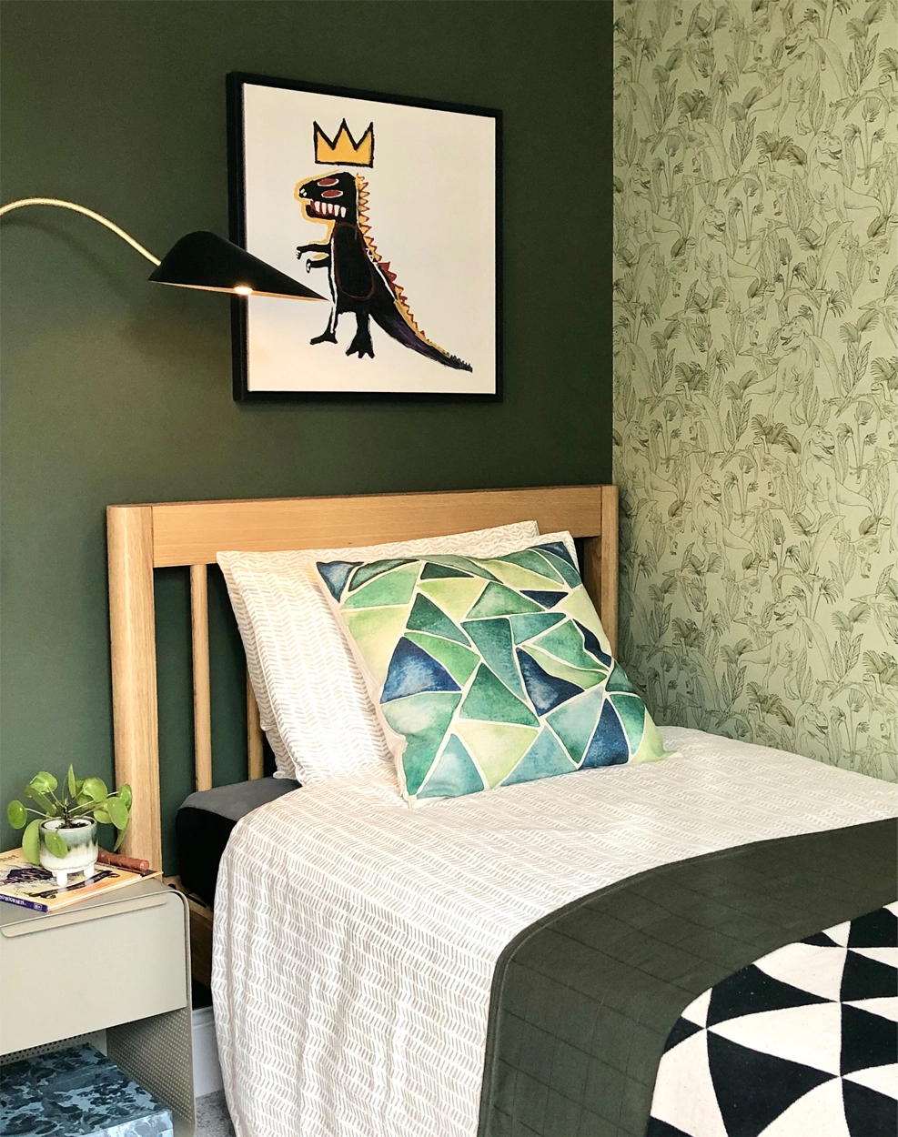 Child's room in dark green with dinosaur wallpaper
