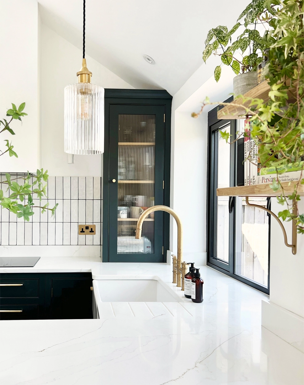 Classic meets industrial style kitchen with worktop flowing into the window - design by First Sense Interiors