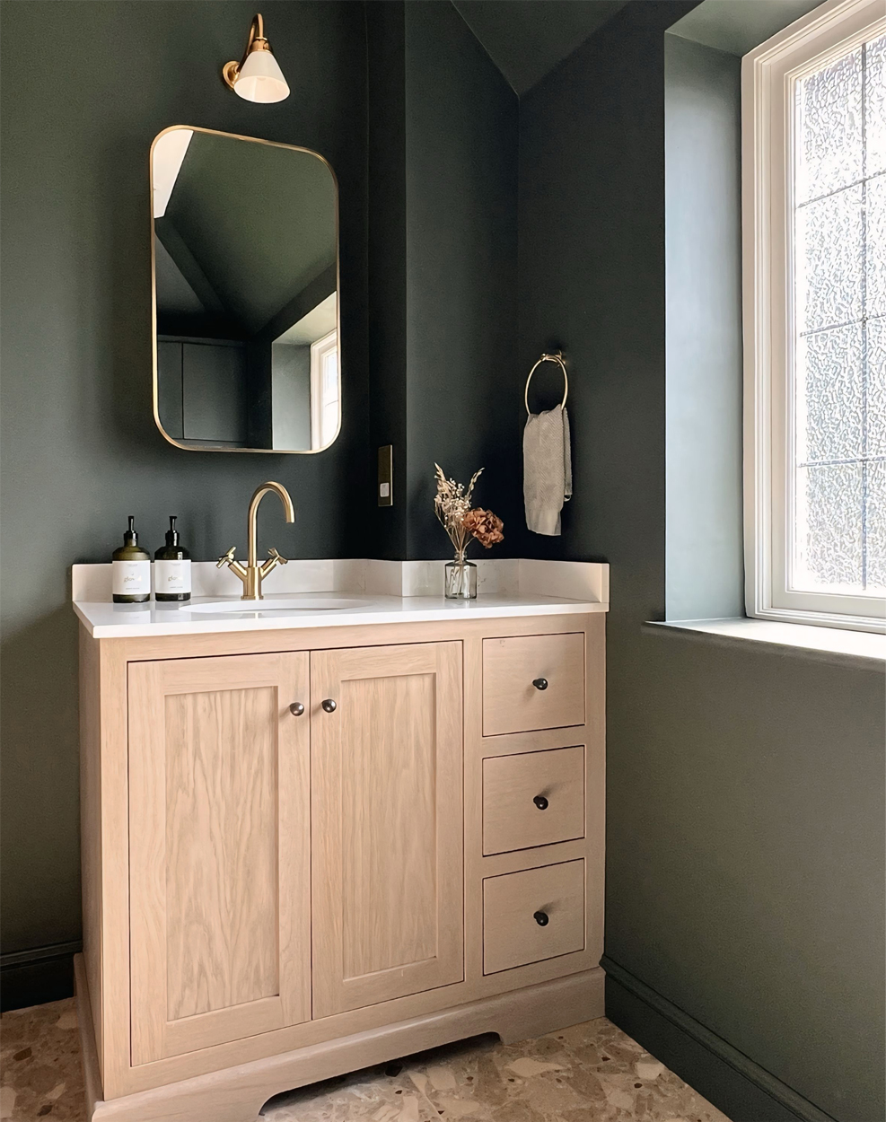 Dark green ensuite shower room bathroom with custom oak basin vanity - design by First Sense Interiors